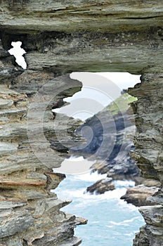 View of coastine through stone portal