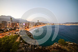 View of the coastline in Benidorm at sunset with city lights