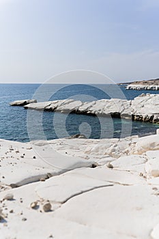 view of coastline and landmark big white chalk rock at Governor\'s beach,Limassol, Cyprus. Steep stone cliffs and deep blue