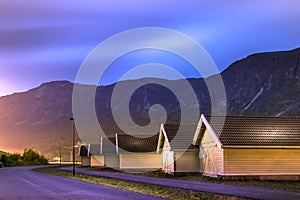 View of the coastline road Fv331 and the wooden houses at the port of Skjolden villageat night, Luster, Norway