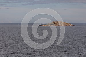 View at the coastline in Sweden a baltic sea with heavy clouds and big rocks coming out of the sea