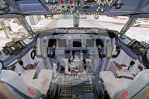 A view of the cockpit of a large commercial airplane a cockpit . Cockpit view of a aircraft cruising Control panel in a plane