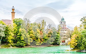View on Colorful autumn landscape in front of Mueller Volksbad of Isar river - Munich photo