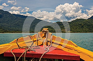 View of colorful boat bow with sea, forest and sunny sky near Paraty. photo