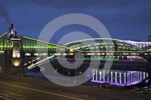 View of the colorful Bogdan Khmelnitsky bridge illuminated at night reflecting in the Moskova river at night