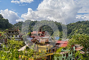 View of colorful buildings surrounded by green mountains, Kathmandu, Nepal