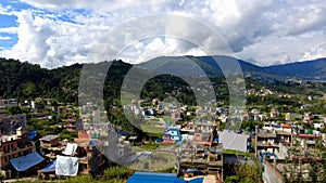 View of colorful buildings surrounded by green mountains, Kathmandu, Nepal. Time lapse