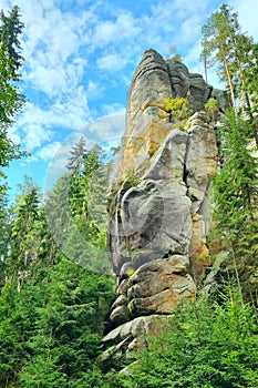 View of a colorful rock against a blue sky with white clouds