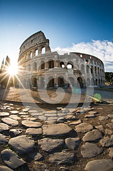 View of the Colosseum in Rome and morning sun, and roman stones, Italy, Europe