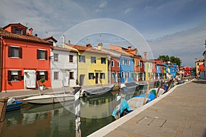 View of the colourful buildings lining cannal, Island of Burano, Venice Italy