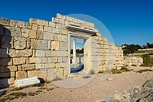 View of the column of the ancient temple through the arch of the entrance