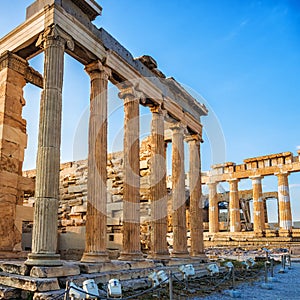 View of columns of Erechtheion and Parthenon on Acropolis, Athens, Greece against blue sky