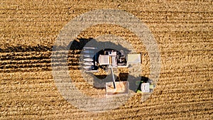 view of combine harvester unloading corn in tractor trailer