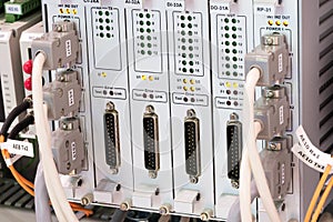 View of communication port module on PLC unit in control box of automation machine