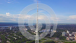 View of communication towers with blue sky, mountain and cityscape background. Video. Top view of the radio tower in the