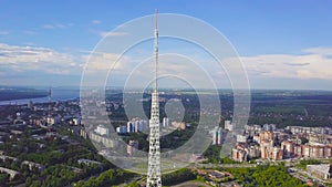 View of communication towers with blue sky, mountain and cityscape background. Video. Top view of the radio tower in the
