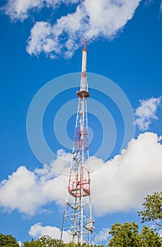 View of communication towers with blue sky. Top view of the radio tower in the city