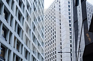 View of concrete office building, urban background, crossing skyscrapers