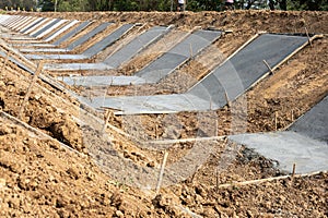 View of the concrete wall construction structure which is attached to the soil