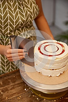View of confectioner using smoother while photo