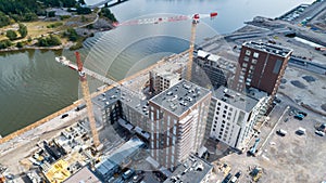 View of a construction crane from above looking down onto a metropolitan city scape during daytime