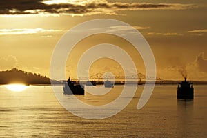 View from container ship on the other merchant cargo vessels anchored near to entrance to Columbia river from Pacific ocean.