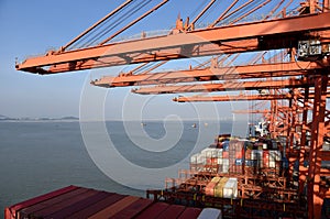 View on the container terminal and gantry cranes loading containers on the cargo ship