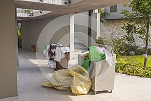 View of containers with dirty bed clothes at hotel`s backyard.