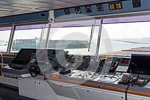 View of the control console on the navigational bridge of the cargo container ship.