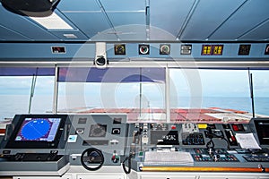 Control console on the navigational bridge of the cargo container ship. photo