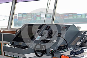 View of the control console on the navigational bridge of the cargo container ship.