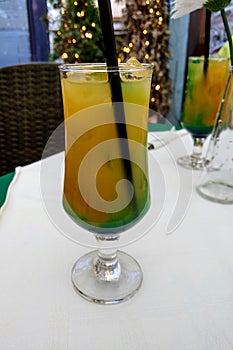 View of a cool glass of cocktail on a table on a hot day, freshness, coolness
