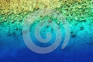 View on the coral reef. Azure water background from top view. Summer seascape from air.