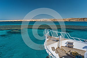 View at the coral sea and white yacht. Perfect place for snorkeling. Summer vacation at sea