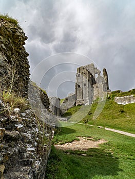 View of Corfe Castle ruins with dramatic sky