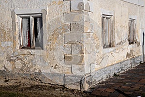 View of a corner of an old, weathered house with windows photo