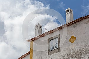 View of cornice and upper corner of building facade, traditional chimney