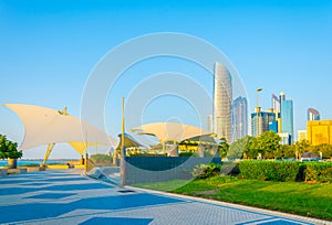 View of a corniche in Abu Dhabi stretching alongside the business center full of high skyscrapers....IMAGE