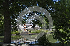 View of a cosy relaxation area under awnings with tables and chairs on the shores of Lake Ariana