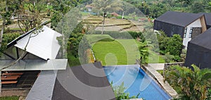 View at cottage with ricefield and swimming pool
