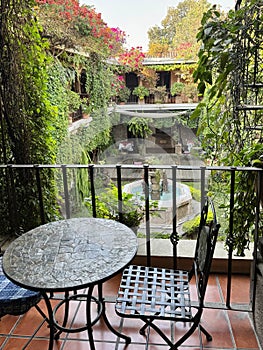 View of the courtyard from the terrace with table and chair above in Guatemala