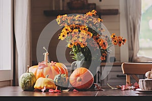 view of cozy autumn breakfast at country house with tea, bagel and seasonal decorations