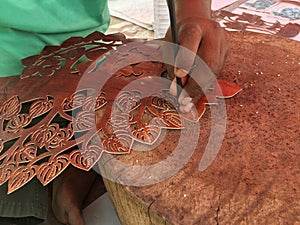 View of craftsman carves leather
