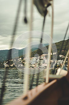 View of Croatian houses in the mountains through the sailing ropes of ships. cloudy day