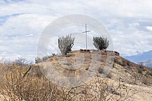 View of the cross of Pavas, surrounded by various vegetation and stones, located in Caraz, Ancash - Peru.