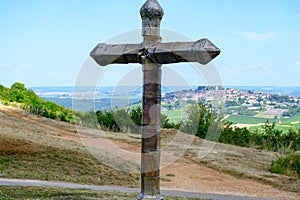 View on cross and Sancerre, medieval hilltop town in Cher department, France overlooking Loire valley with Sancerre Chavignol