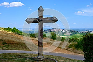 View on cross and Sancerre, medieval hilltop town in Cher department, France overlooking Loire valley with Sancerre Chavignol