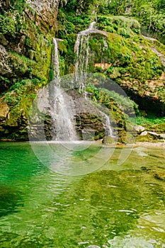 View of crystal clear water and small pond with waterfalls in the middle of the Triglav national park. Slap Virje, Virje waterfall