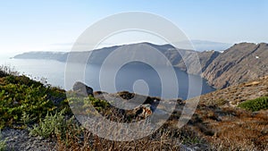 View of the curving bay towards Oia in Santorini, Greece