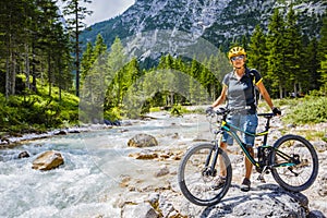 View of cyclist riding mountain bike on trail in Dolomites,Tre C